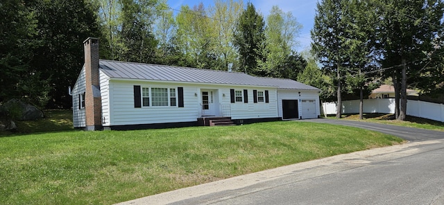 645 Kennebec St, Rumford, ME 04276 - view of front of property with a chimney, an attached garage, asphalt driveway, metal roof, and a standing seam roof