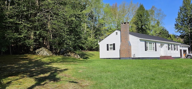 645 Kennebec St, Rumford, ME 04276 - back of property featuring a yard, a chimney, and metal roof