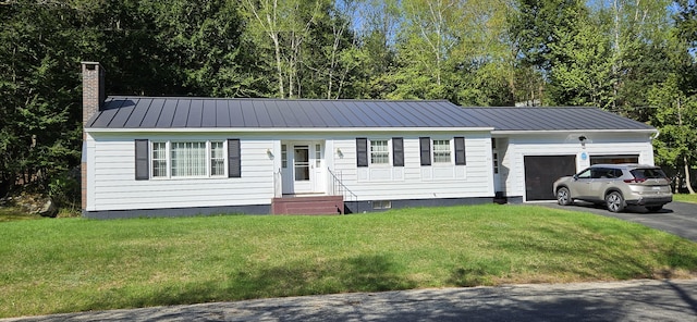 645 Kennebec St, Rumford, ME 04276 - view of front of home with a chimney, a garage, metal roof, asphalt driveway, and a front yard