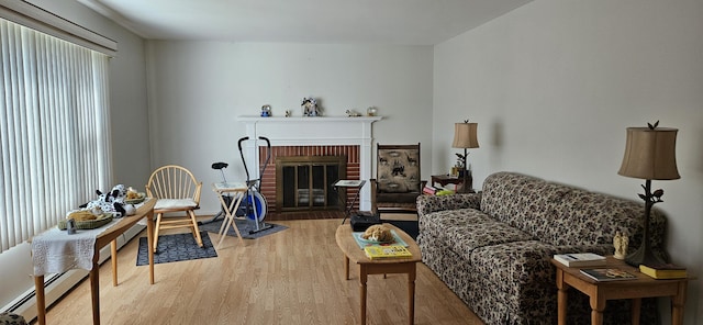 645 Kennebec St, Rumford, ME 04276 - living area with wood finished floors, a fireplace, and baseboard heating