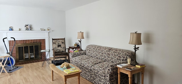 645 Kennebec St, Rumford, ME 04276 - living room featuring wood finished floors and a brick fireplace