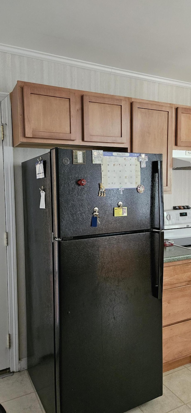 645 Kennebec St, Rumford, ME 04276 - kitchen with freestanding refrigerator, light tile patterned floors, ventilation hood, and white range with electric stovetop