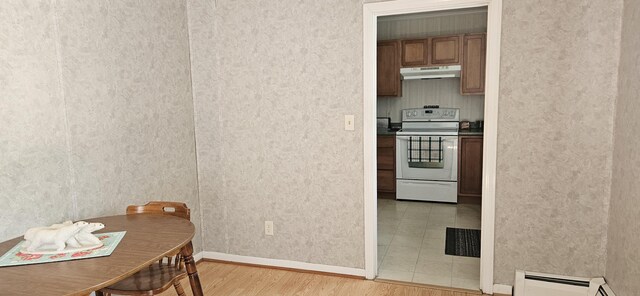 645 Kennebec St, Rumford, ME 04276 - dining area featuring light wood finished floors, baseboard heating, baseboards, and wallpapered walls