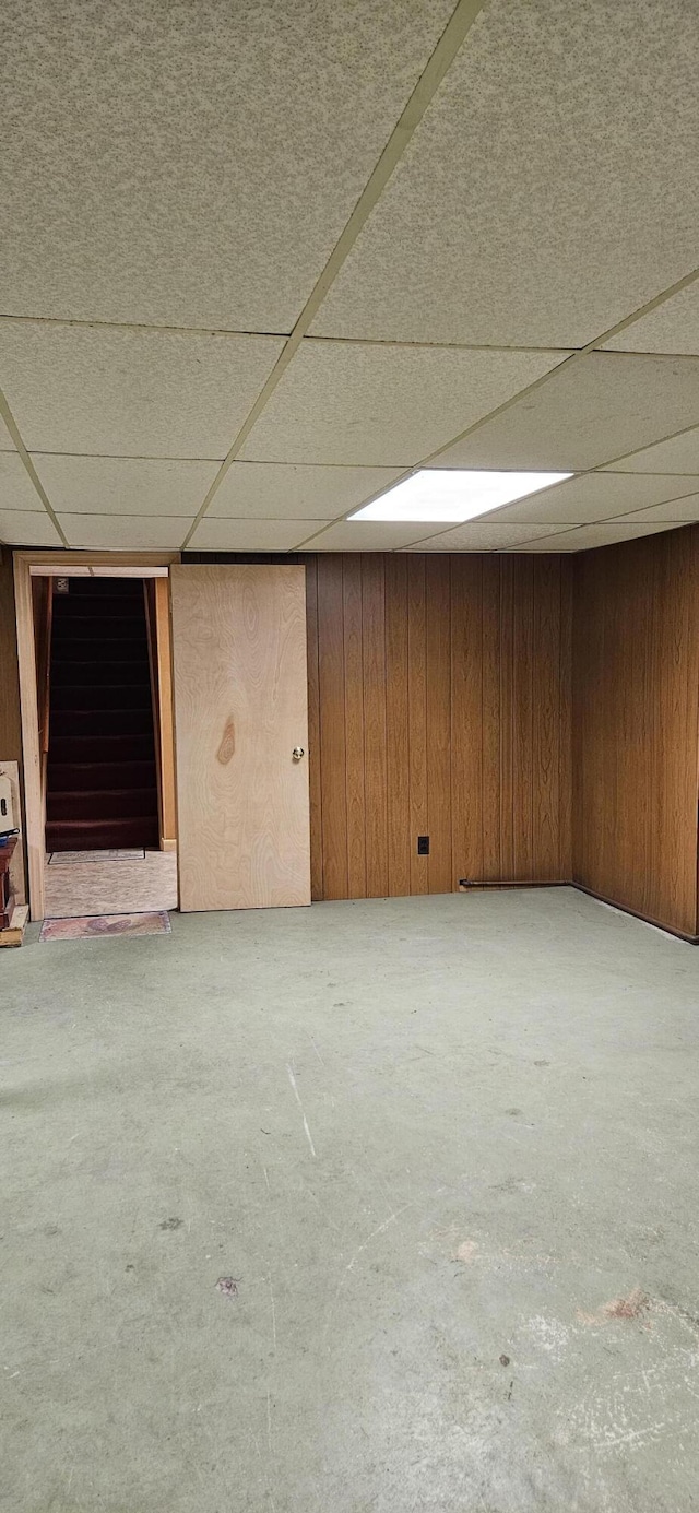 645 Kennebec St, Rumford, ME 04276 - finished below grade area with wood walls, stairway, and a paneled ceiling