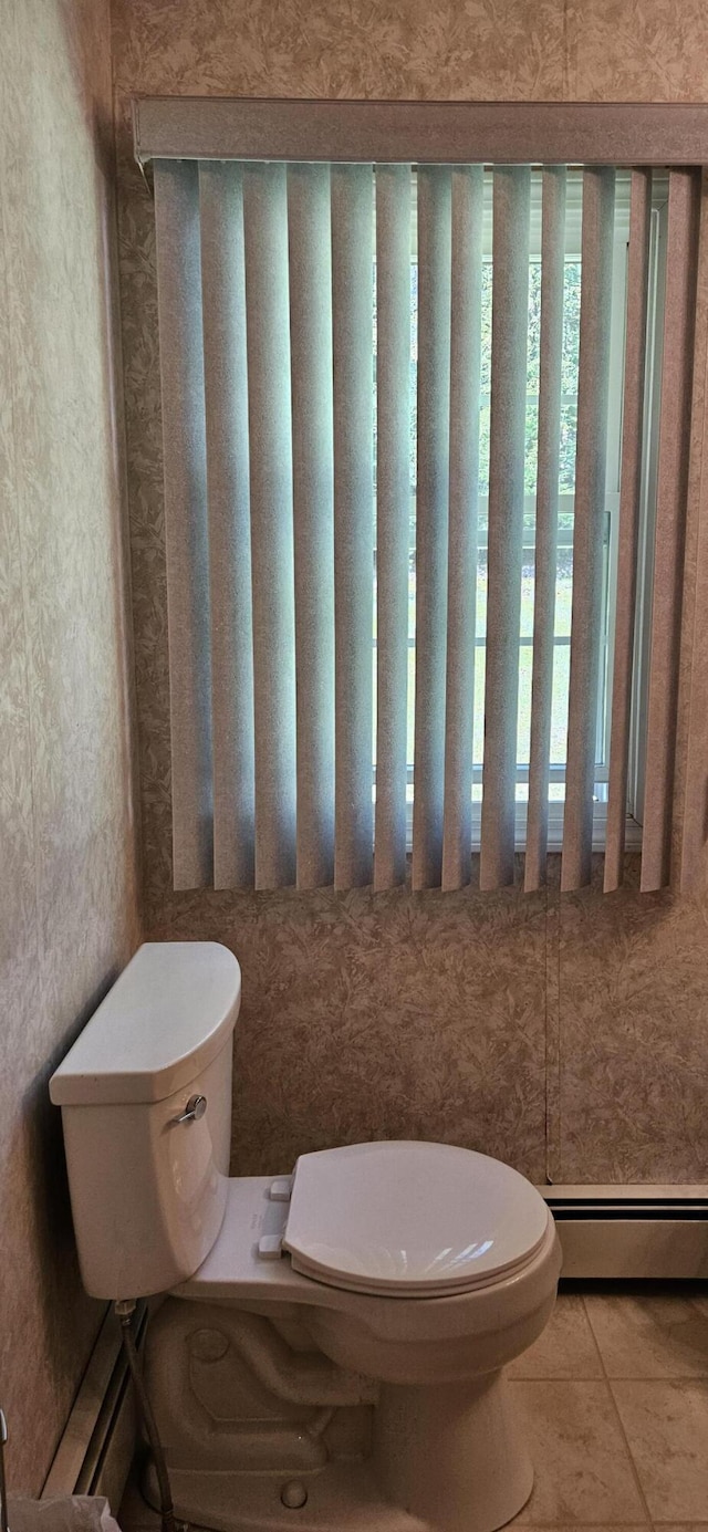 645 Kennebec St, Rumford, ME 04276 - bathroom featuring a baseboard radiator, toilet, and tile patterned floors