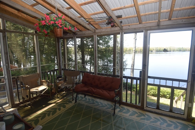sunroom / solarium with a water view
