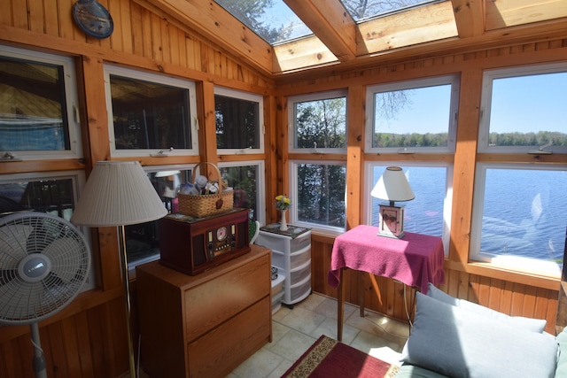 sunroom featuring a skylight and wood walls