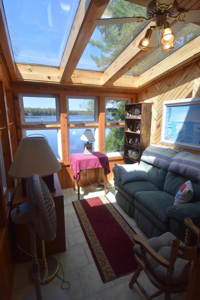 sunroom featuring a skylight and wooden walls