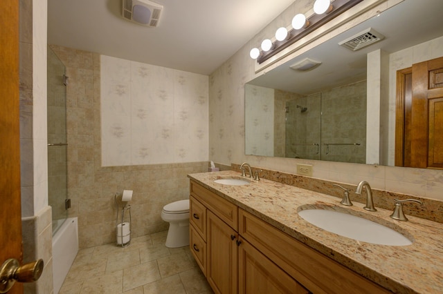 9 Ridge Rd, Westbrook, ME 04092 - bathroom with tile walls, wallpapered walls, toilet, tiled shower / bath combo, and tile patterned flooring