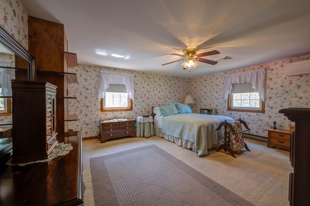 9 Ridge Rd, Westbrook, ME 04092 - bedroom featuring wallpapered walls, a wall mounted AC, multiple windows, a baseboard heating unit, and light carpet