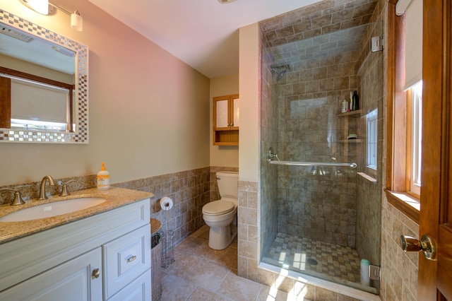 9 Ridge Rd, Westbrook, ME 04092 - full bathroom with tile walls, toilet, a shower stall, a wainscoted wall, and vanity