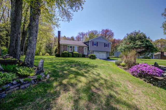 9 Ridge Rd, Westbrook, ME 04092 - view of front of home with a garage, a chimney, a front yard, and asphalt driveway