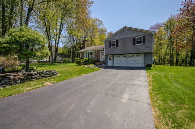 9 Ridge Rd, Westbrook, ME 04092 - split level home featuring an attached garage, driveway, a front yard, and a chimney
