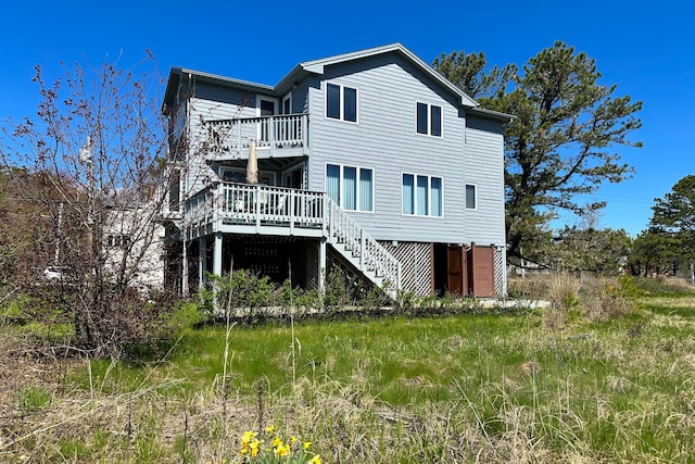 back of house featuring a wooden deck and stairway