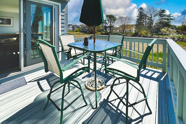 wooden terrace with outdoor dining area
