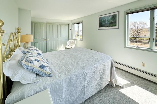 bedroom featuring carpet, baseboard heating, and a closet