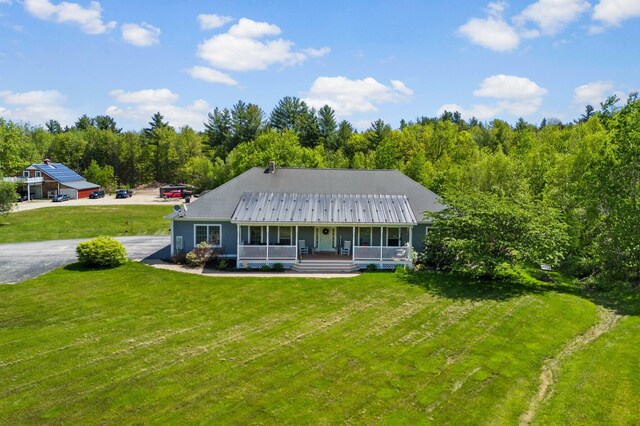 29 Gabriels Way, Turner, ME 04282 - view of front of home featuring a porch, a front lawn, metal roof, and a forest view