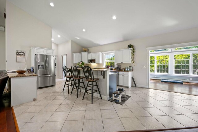 29 Gabriels Way, Turner, ME 04282 - kitchen featuring stainless steel fridge with ice dispenser, a kitchen breakfast bar, white cabinets, a kitchen island, and light tile patterned flooring