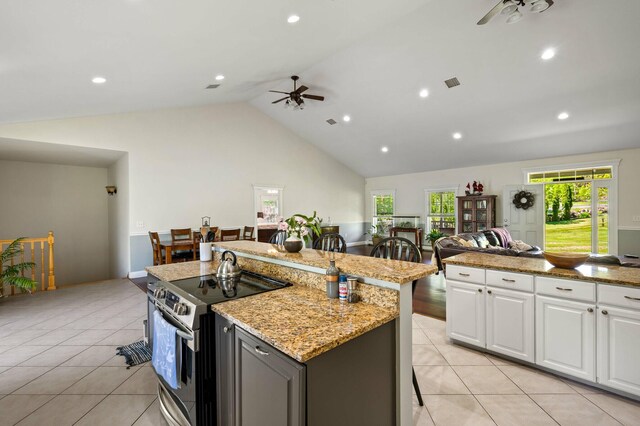 29 Gabriels Way, Turner, ME 04282 - kitchen featuring stainless steel electric range, a ceiling fan, a center island, white cabinetry, and high vaulted ceiling