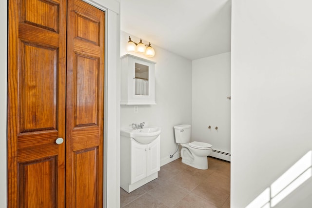 29 Gabriels Way, Turner, ME 04282 - full bath featuring baseboard heating, vanity, toilet, tile patterned floors, and baseboards