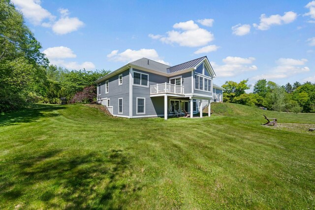 29 Gabriels Way, Turner, ME 04282 - rear view of house featuring a lawn, a standing seam roof, metal roof, and a wooden deck