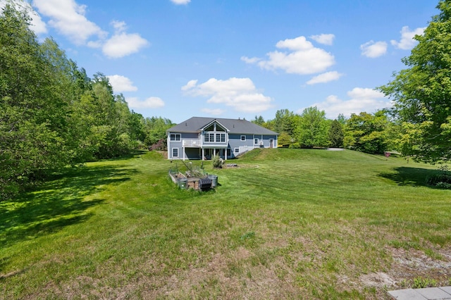 29 Gabriels Way, Turner, ME 04282 - back of house with a lawn and a balcony