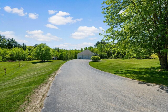 29 Gabriels Way, Turner, ME 04282 - view of front of house featuring a garage, a front yard, and an outbuilding