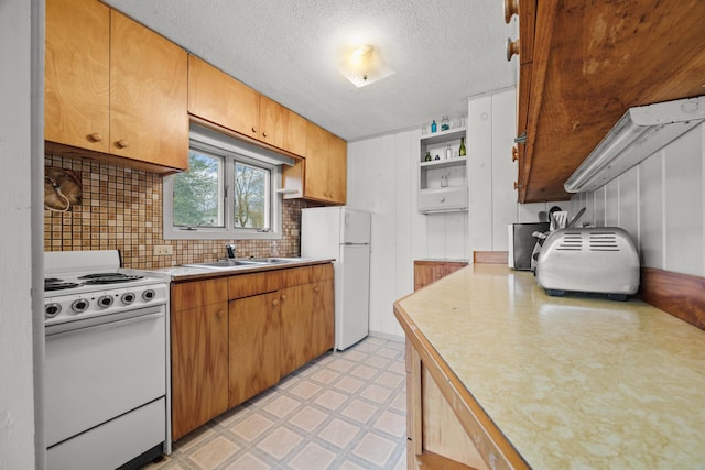 16 Columbia Ave, Tremont, ME 04612 - kitchen featuring white appliances, a sink, light countertops, light floors, and backsplash