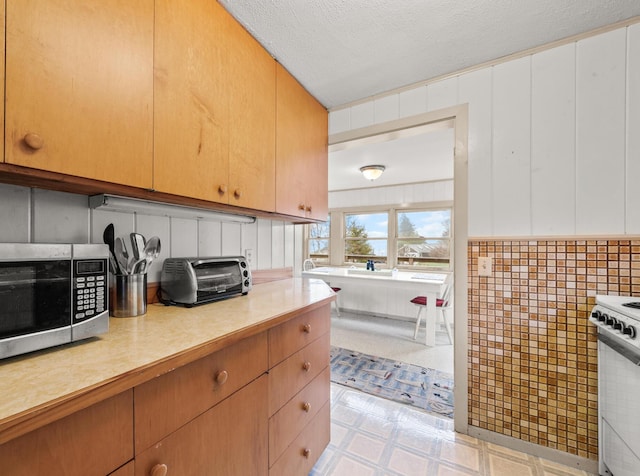 16 Columbia Ave, Tremont, ME 04612 - kitchen with stainless steel microwave, electric range, light flooring, light countertops, and a textured ceiling