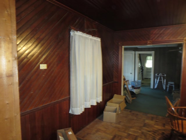 hall featuring wooden walls