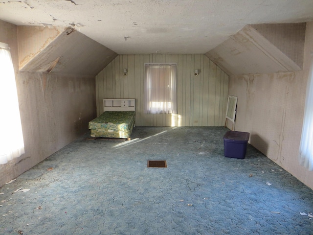 bonus room featuring lofted ceiling and carpet