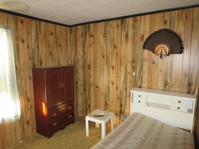 bedroom with wooden walls and carpet floors