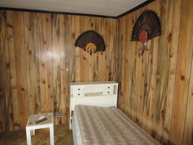 carpeted bedroom with wooden walls