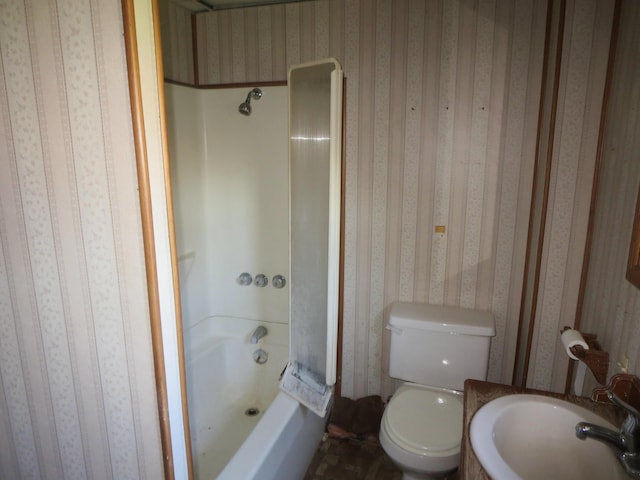 bathroom with wallpapered walls, a sink, toilet, and shower / bathtub combination