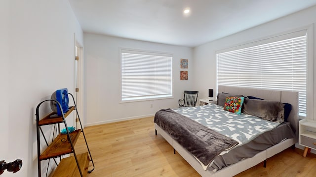 bedroom with light wood-style flooring and baseboards