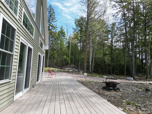 wooden deck featuring an outdoor fire pit