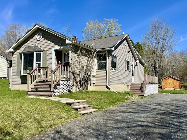 5 Mayo St, Caribou, ME 04736 - view of front of property with a shed, an outdoor structure, and a chimney