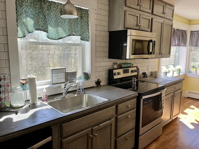 5 Mayo St, Caribou, ME 04736 - kitchen with stainless steel appliances, dark countertops, a sink, and dark wood-style floors
