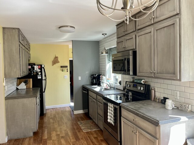 5 Mayo St, Caribou, ME 04736 - kitchen with appliances with stainless steel finishes, dark countertops, a sink, and backsplash