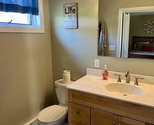 5 Mayo St, Caribou, ME 04736 - bathroom featuring vanity, toilet, and a baseboard heating unit