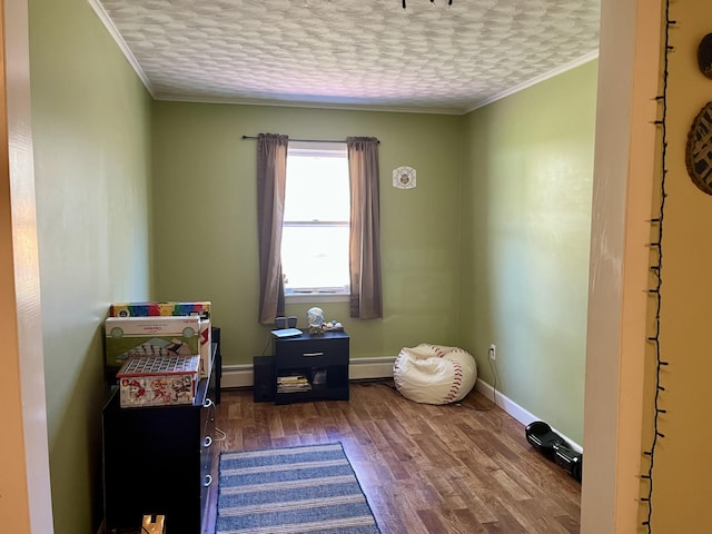 5 Mayo St, Caribou, ME 04736 - miscellaneous room featuring wood finished floors, a baseboard radiator, ornamental molding, baseboards, and a textured ceiling