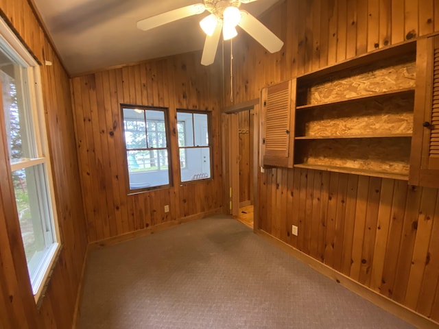 39 Salmon Rd, Madison, ME 04950 - unfurnished room with wooden walls, vaulted ceiling, plenty of natural light, a ceiling fan, and carpet flooring