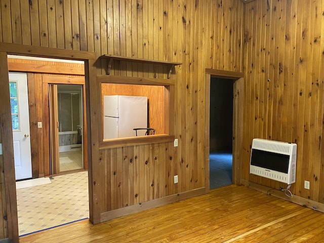 39 Salmon Rd, Madison, ME 04950 - unfurnished living room with heating unit, wood finished floors, and wood walls