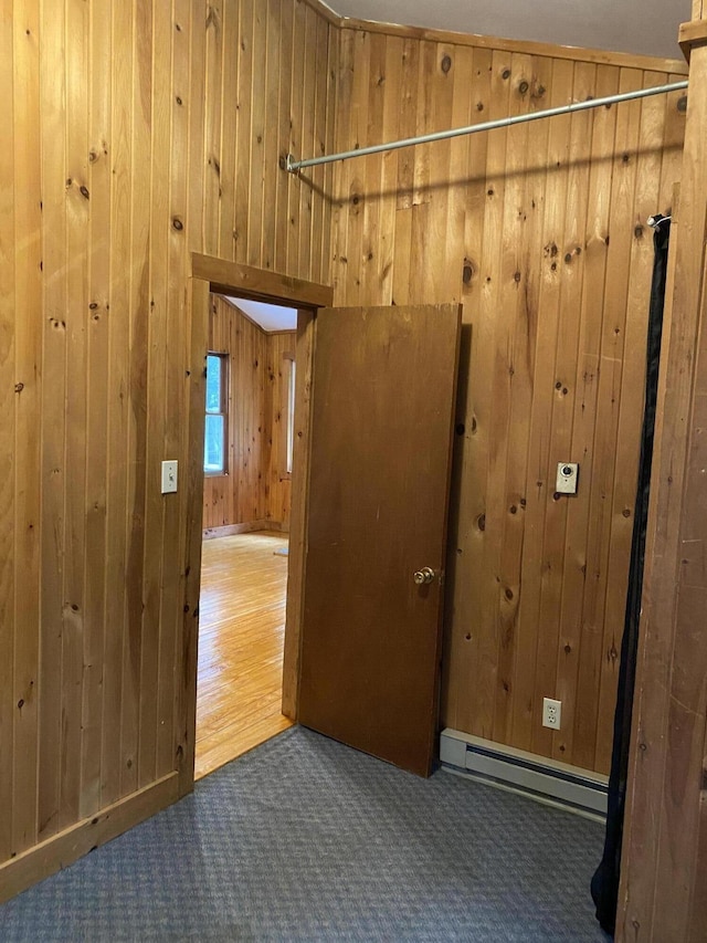 39 Salmon Rd, Madison, ME 04950 - hallway featuring baseboard heating, wood walls, and carpet flooring