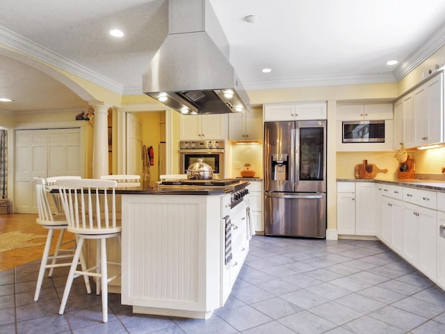 16 Davis Point Rd, Wayne, ME 04284 - kitchen with stainless steel appliances, island exhaust hood, ornate columns, crown molding, and a center island