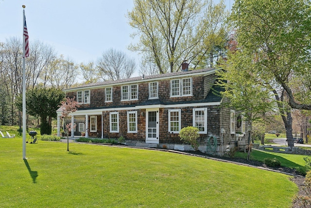 378 Pool St, Biddeford, ME 04005 - view of front of home with a front yard and a chimney