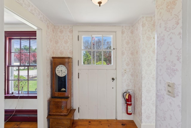 378 Pool St, Biddeford, ME 04005 - entryway with plenty of natural light, wallpapered walls, wood finished floors, and ornamental molding
