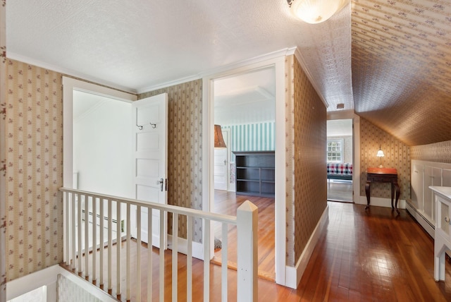 378 Pool St, Biddeford, ME 04005 - additional living space featuring wood-type flooring, wallpapered walls, a baseboard radiator, vaulted ceiling, and baseboards