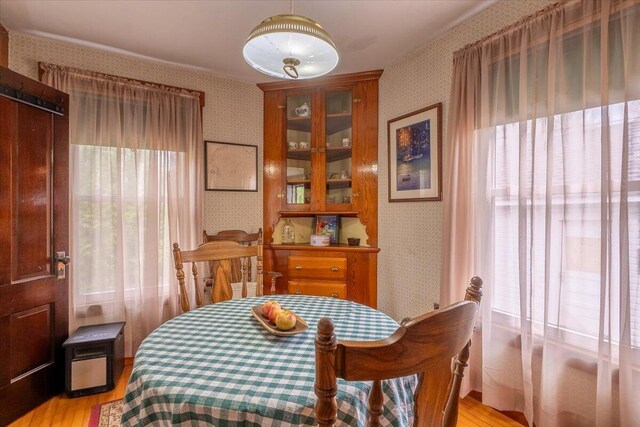 127 Harbor Rd, Friendship, ME 04547 - dining room featuring wallpapered walls, healthy amount of natural light, and light wood finished floors