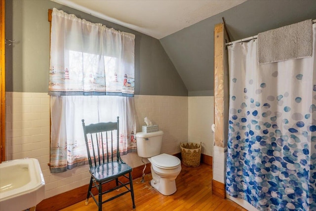 127 Harbor Rd, Friendship, ME 04547 - bathroom featuring tile walls, wood finished floors, vaulted ceiling, toilet, and curtained shower